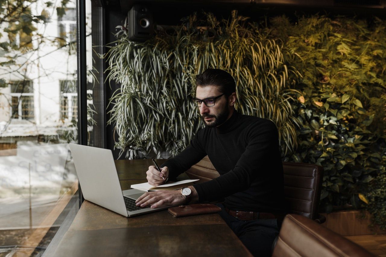 Man remote working in cafe